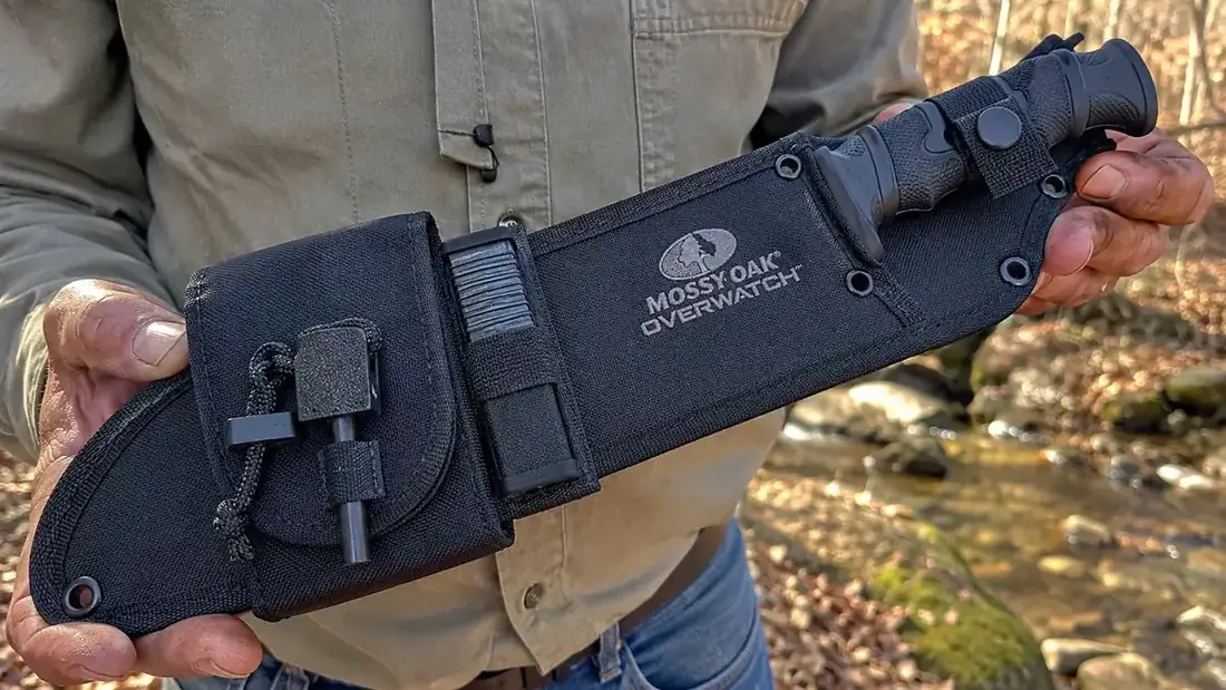 Close-up of a fixed blade knife's full tang construction and sheath with a built-in sharpener pouch