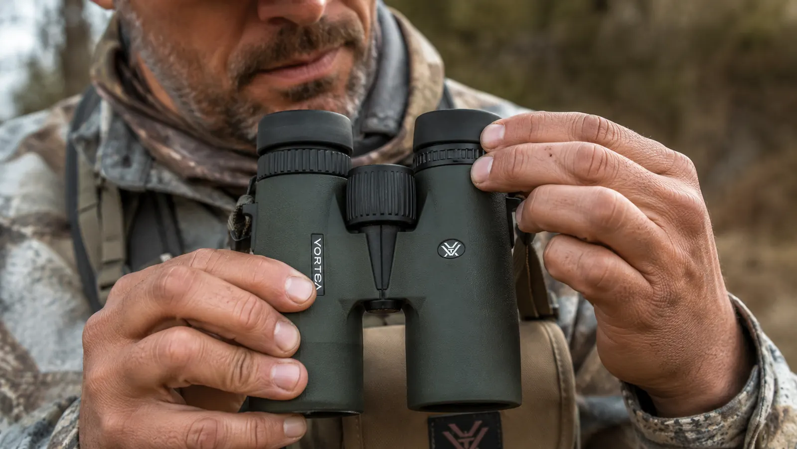 Close-up of hands adjusting the diopter ring on the Vortex Crossfire HD binoculars